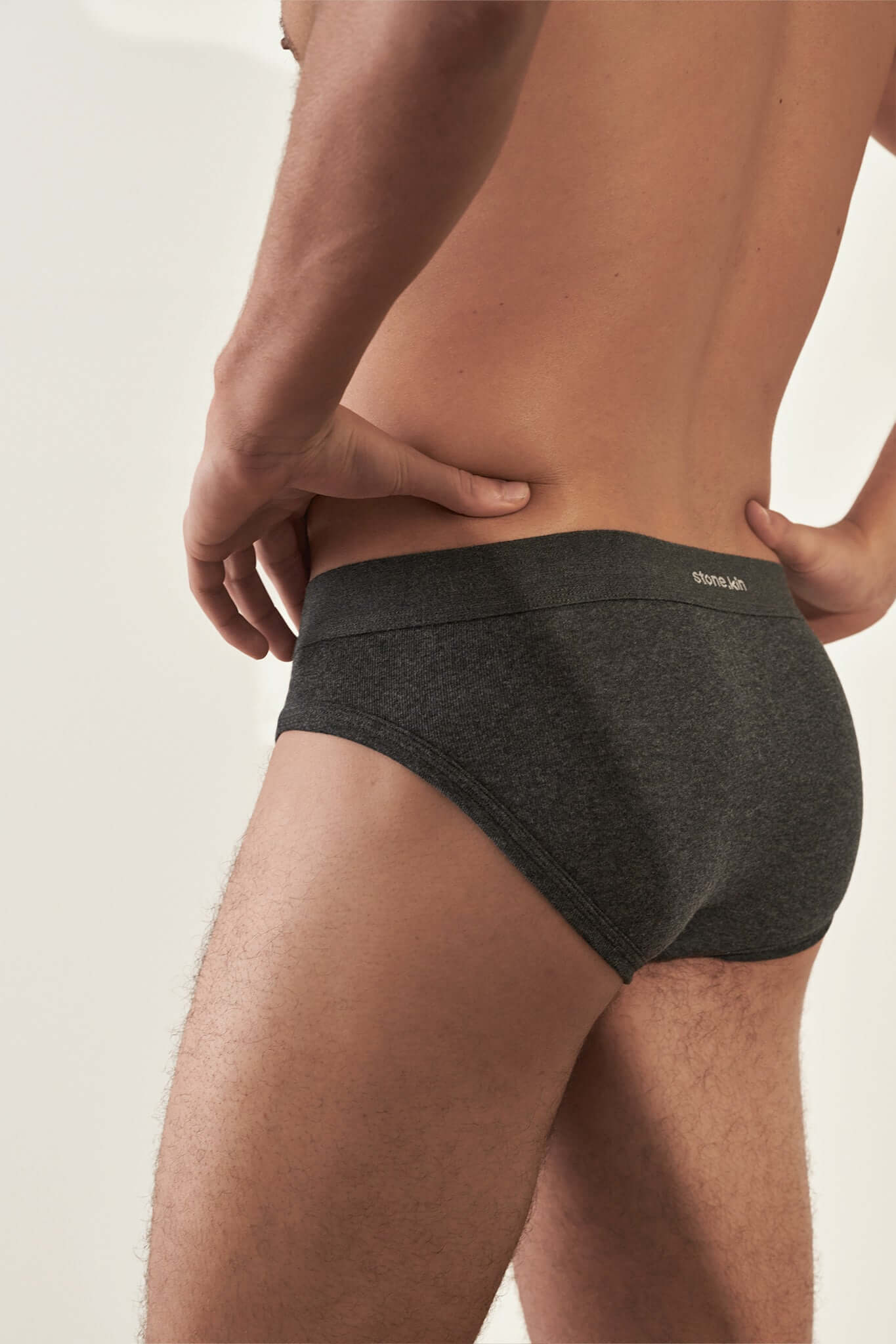 Men's Brief 3 Pack in Organic Cotton in Tar shown from the back, featuring a snug fit and soft organic cotton.