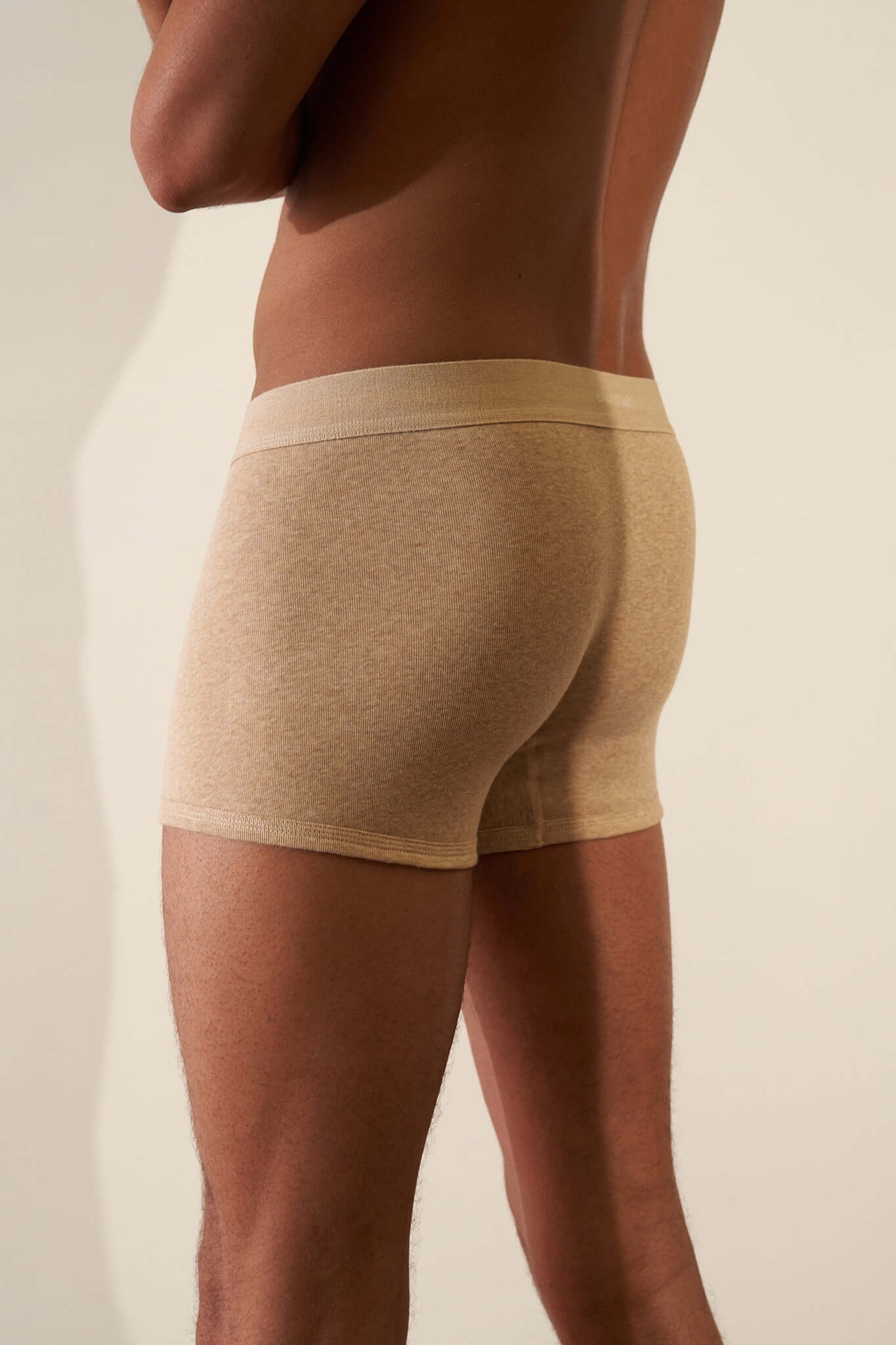 Boxer Brief 3 Pack in Organic Cotton - model wearing Papaya colored boxer briefs from behind.