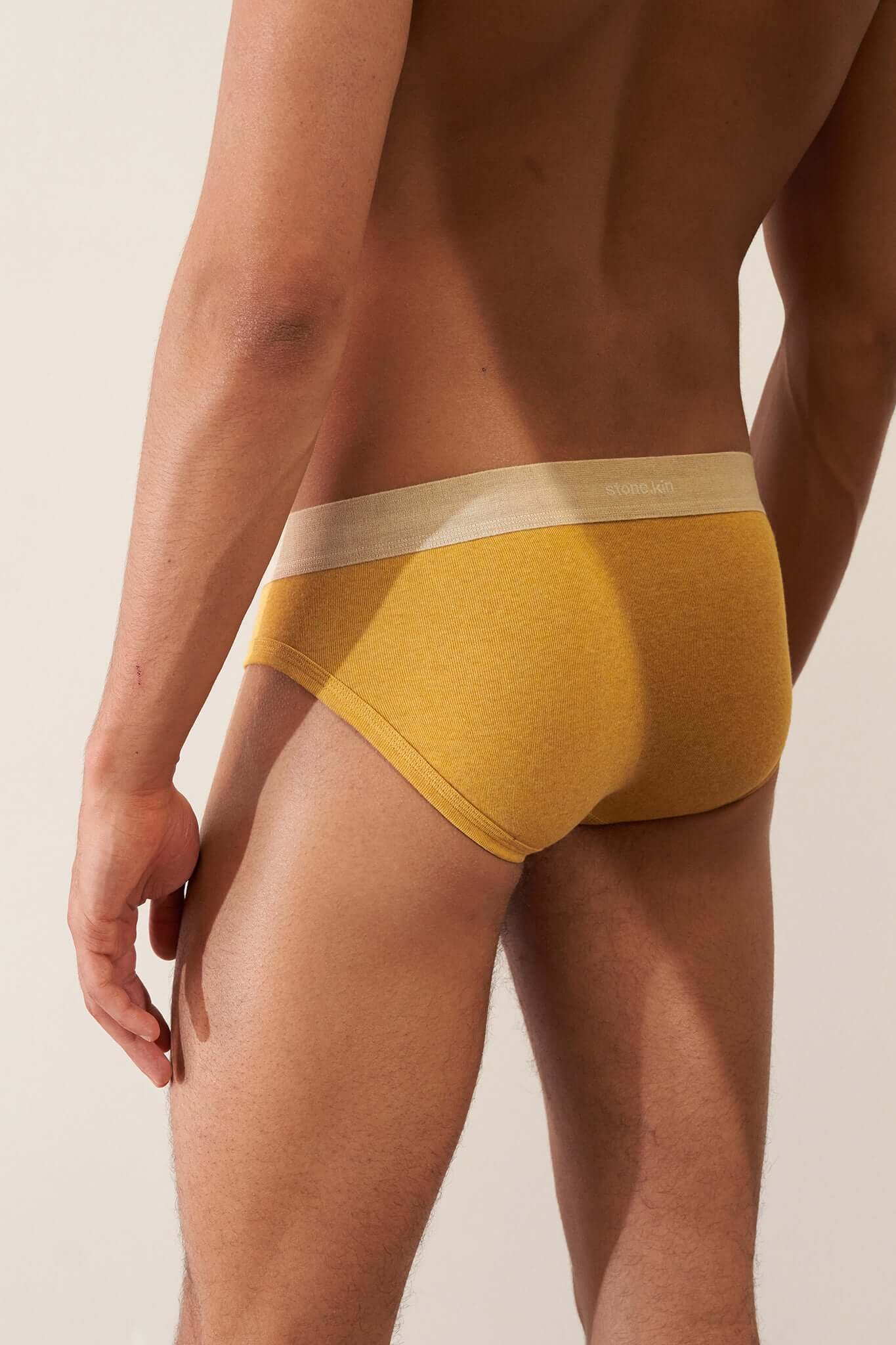 Stonekin Men's Organic Cotton Brief 3-Pack in Mustard, Sand, and Tar colours, designed for a comfortable fit with soft organic cotton fabric.